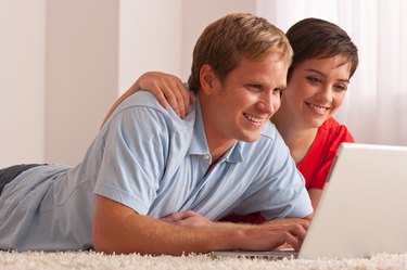 Couple relaxing with laptop