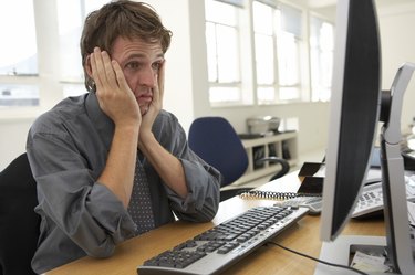 Frustrated businessman looking at computer