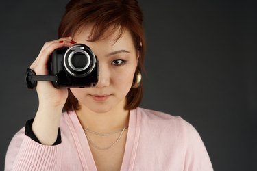 Woman filming with video camera