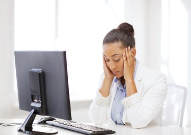 stressed african woman with computer