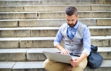 Hipster businessman with laptop