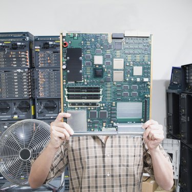 Man hiding behind circuit board
