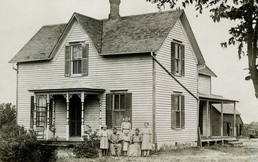 Family standing in front of house