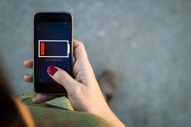 Woman walking smartphone low battery