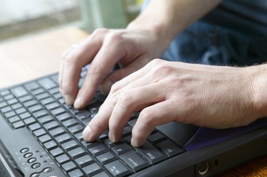 Man typing on keyboard