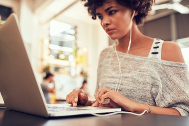 Woman looking busy working on laptop at cafe