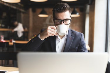 Young businessman working on his laptop in a cafe shop