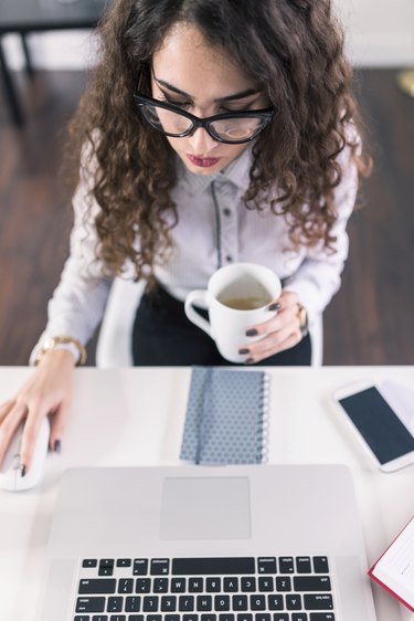 Advertising Account Executive working on her laptop in her offic