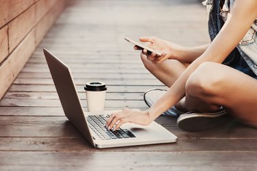 Girl using a laptop and smart phone