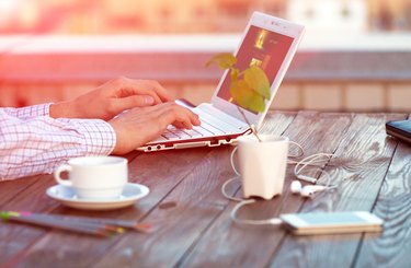 Freelance work at wood Table located on outdoor terrace