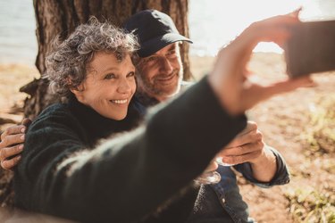 Senior couple at campsite taking selfie