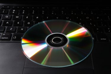 Top angle view of a CD and a laptop