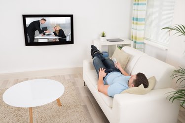 Relaxed Man Watching Movie In Living Room