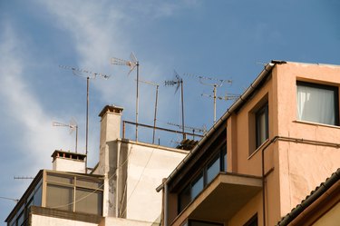 Chimneys and antennae on roof of building in Spain