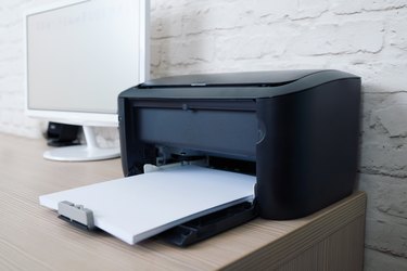 printer with paper on workplace