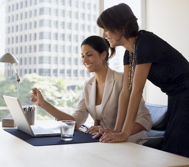 Businesswomen working on laptop computer