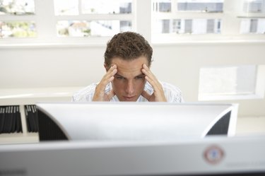 Frustrated businessman looking at computer