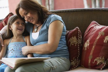 Hispanic grandmother reading to granddaughter