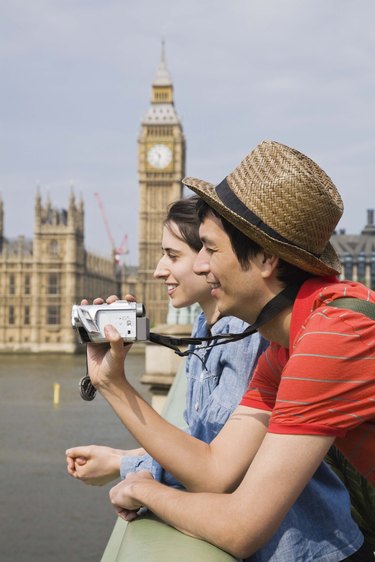 Couple with video camera, London, England