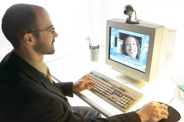 Businessman video conferencing at computer with webcam