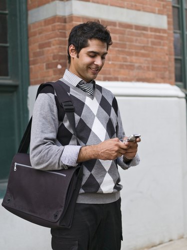 Business man texting on cell phone