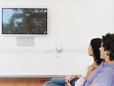 Couple Watching a Flat Screen TV in Their Home