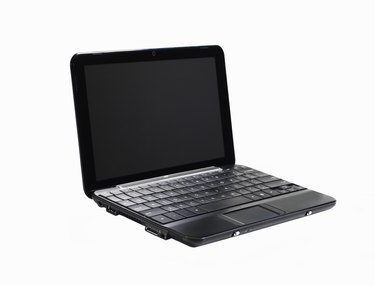 Black laptop on white, side angle view.