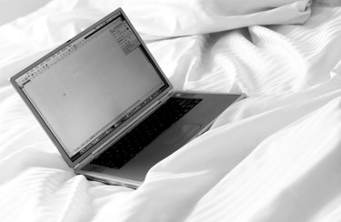 Laptop on a bed