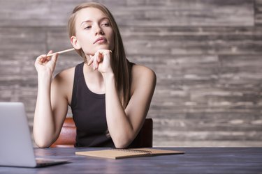 Thoughtful girl with pencil