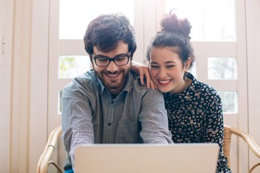 Cute young couple with laptop