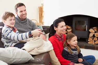 Family Relaxing Indoors Watching Television Together
