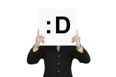 Businessman hold board with smile face emoticon