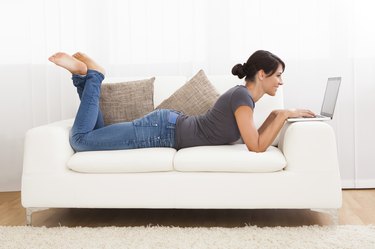 Beautiful Young Woman On A Sofa