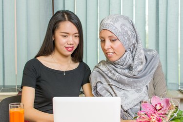 Asian and muslim girls working on a laptop