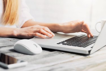 Ffemale hands on laptop keyboard