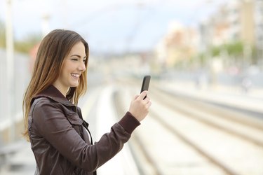 Woman browsing social media in a train station