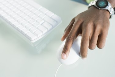 High angle view of a man's hand operating a computer mouse