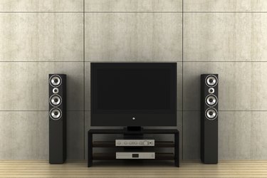 modern tv with speakers in front of gray wall