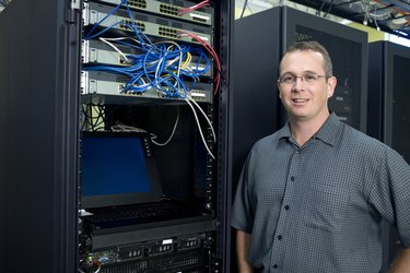 Portrait of a technician standing in a server room