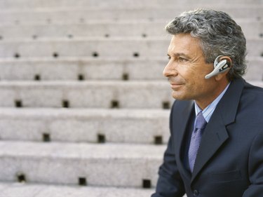 Side view of a mature businessman wearing a headset
