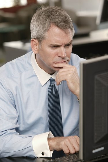 Pensive businessman using computer