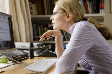 Woman studying computer screen