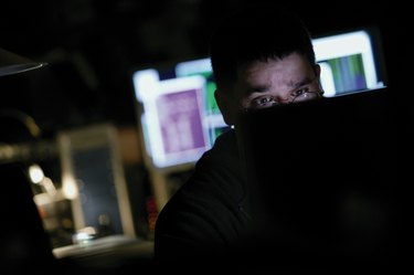 Man working at computer in dark