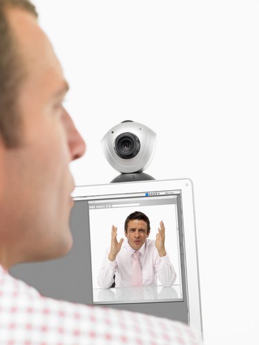 Businessmen communicating on webcam