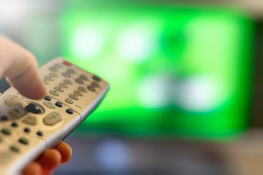 Close-up of TV remote control over a blurred background