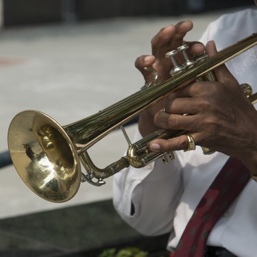 Mid section view of a man playing a trumpet, Chicago, Cook County, Illinois, USA