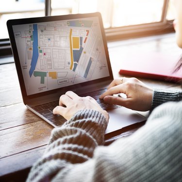 Asian Lady Looking at City Map Plan Concept