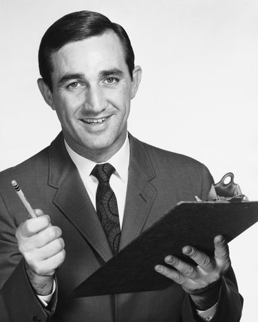 Man holding clipboard and pencil