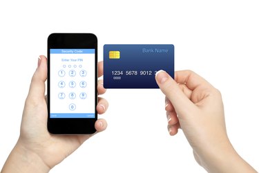 female hands holding phone and credit card
