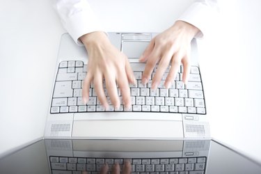 Person typing on laptop